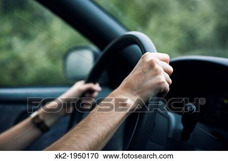 Stock Image - "Detail of driver hands, scared of car accidents". Fotosearch