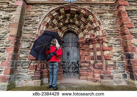 "Exterior view of St. Magnus Cathedral with woman in the door in the city of Kirkwall, Mainland Island, Orkney Archipelago, Scotland. " View Large Photo Image Stock Photo - "Exterior view of St. Magnus Cathedral with woman in the door in the city of Kirkwall, Mainland Island, Orkney Archipelago, Scotland. ". Fotosearch