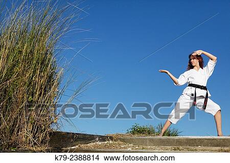 Picture - Female martial arts expert practicing.. Fotosearch