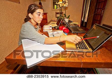 Stock Photography - "France, Alpes-Maritimes, Mandelieu la Napoule, schoolgirl to work with computers. ". Fotosearch