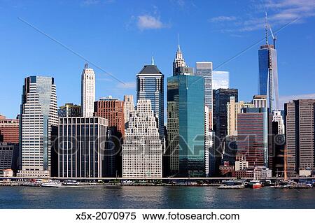 Stock Photography - "Freedom Tower rises above the Lower Manhattan skyline in New York city, USA. ". Fotosearch