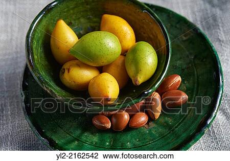 Stock Image - Fresh Argan nuts with outer skins and Argan nuts in their shells.. Fotosearch