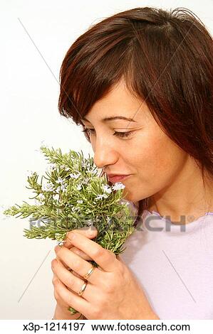 Stock Photo - Girl smelling rosemary. Fotosearch