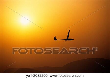 Stock Image - "Glider plane ASH-25 flying on sunset near Santa Cilia de Jaca, Aragon, Spain. ". Fotosearch