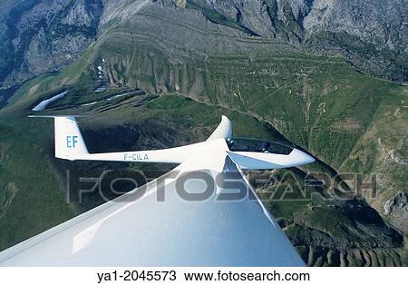 "Glider plane Duo Discus flying over Las Blancas mountains, Aragon, Spain. " View Large Photo Image Stock Image - "Glider plane Duo Discus flying over Las Blancas mountains, Aragon, Spain. ". Fotosearch