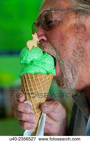 Stock Photo - Grandfather eating ice cream.. Fotosearch