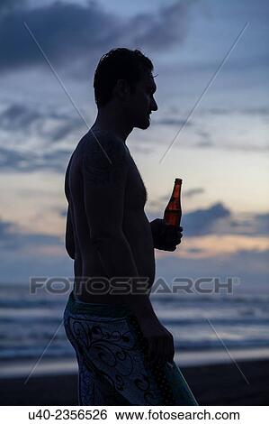 "Guatemala, El Paredon, silohuete of man with beer at sunset. " View Large Photo Image Stock Photograph - "Guatemala, El Paredon, silohuete of man with beer at sunset. ". Fotosearch