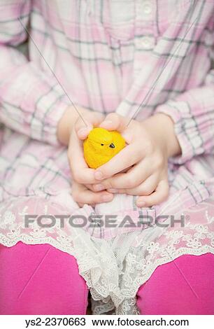 Hands of little girl holding plastic yellow bird. View Large Photo Image Stock Image - Hands of little girl holding plastic yellow bird.. Fotosearch