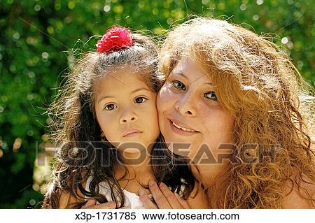 Stock Photography - Hispanic little girl and her mother. Fotosearch