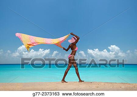 Stock Image - "Jamaican woman on the beach, Ocho Rios, Jamaica". Fotosearch