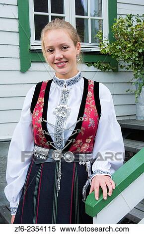 Stock Photography - Laerdal Norway young 18 year old woman in traditional Bunard folk Costume at white house stairs dress clothes MR-5.. Fotosearch