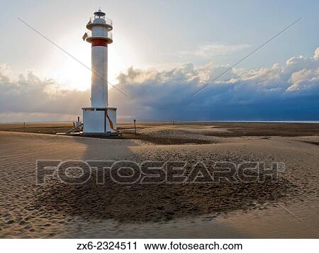 Stock Image - "Lighthouse at Fangar Peninsula. Ebro River Delta Natural Park, Tarragona province, Catalonia, Spain. ". Fotosearch