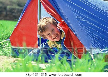 Stock Photography - Little boy and tent. Fotosearch