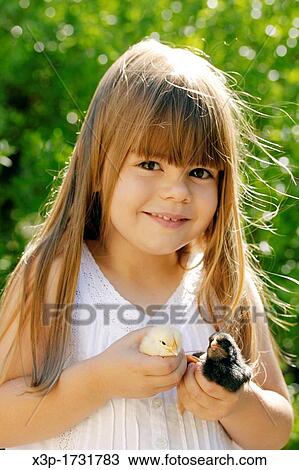Stock Image - Little girl and chicks. Fotosearch