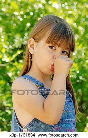 Picture - Little girl sucking a finger. Fotosearch