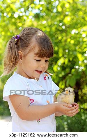 Little girl with chick View Large Photo Image Stock Image - Little girl with chick. Fotosearch