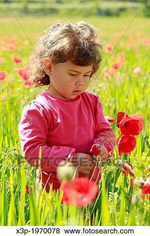 Little girl with flowers. View Large Photo Image Stock Photo - Little girl with flowers.. Fotosearch