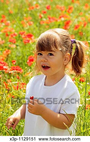 Stock Image - Little girl with poppies. Fotosearch