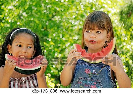 Little girls eating watermelon View Large Photo Image Stock Photograph - Little girls eating watermelon. Fotosearch