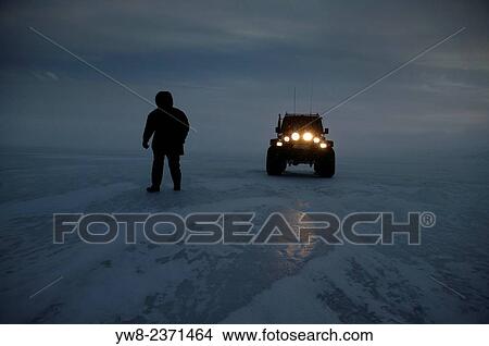 Picture - "Man and large jeep on Lake Hvitarvatn, Langjokull Ice Cap, Iceland. ". Fotosearch