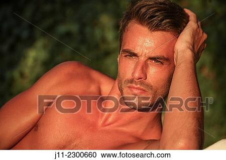 Man lying down on sunlounger View Large Photo Image Stock Image - Man lying down on sunlounger. Fotosearch