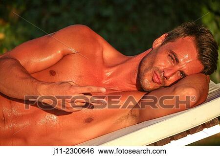 Man lying down on sunlounger View Large Photo Image Stock Photograph - Man lying down on sunlounger. Fotosearch