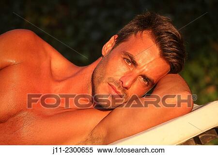 Man lying down on sunlounger View Large Photo Image Stock Photography - Man lying down on sunlounger. Fotosearch