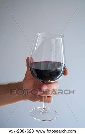 Man´s hand holding a glass of red wine. Close view. View Large Photo Image Stock Photo - Man´s hand holding a glass of red wine. Close view.. Fotosearch