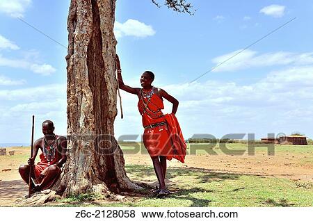 "Massai in the shadow of an acacia tree, Masai Mara, Kenya. " View Large Photo Image Stock Photo - "Massai in the shadow of an acacia tree, Masai Mara, Kenya. ". Fotosearch