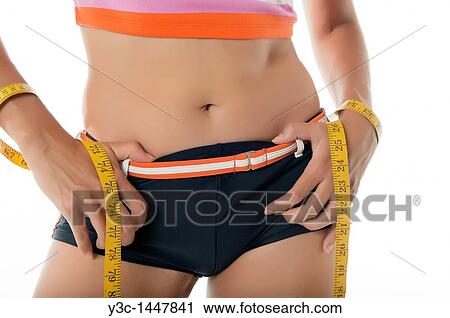 Measuring tape around woman´s waistline View Large Photo Image Stock Image - Measuring tape around woman´s waistline. Fotosearch