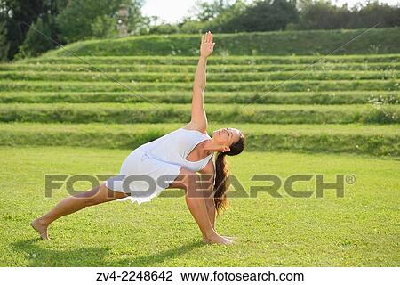 "Middle aged woman doing yoga in a park in summer, Germany. " View Large Photo Image Stock Image - "Middle aged woman doing yoga in a park in summer, Germany. ". Fotosearch
