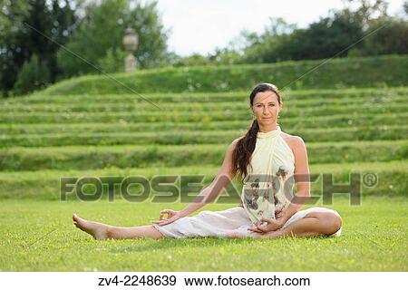 "Middle aged woman doing yoga in a park in summer, Germany. " View Large Photo Image Stock Photo - "Middle aged woman doing yoga in a park in summer, Germany. ". Fotosearch