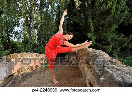 "Middle aged woman doing yoga in a park in summer, Germany. " View Large Photo Image Stock Photograph - "Middle aged woman doing yoga in a park in summer, Germany. ". Fotosearch