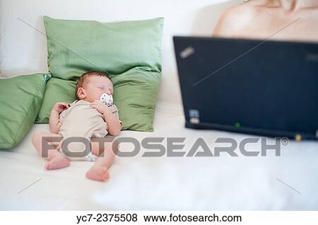 Stock Photo - mother working and baby.. Fotosearch