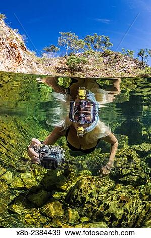 Stock Photo - "National Geographic Orion staff CT Ticknor enjoying a swim at Crocodile Creek, Yampi Bay, Kimberley, Western Australia, Australia. ". Fotosearch