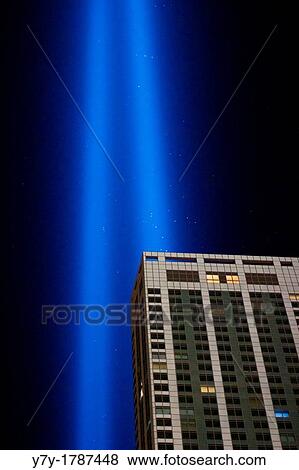 Stock Photo - "New York, NY - September 11, 2012: The twin columns of light of the installation ´Tribute in Light´ rise into the night sky over Manhattan in memory of the 9/11 attacks 11 years ago". Fotosearch