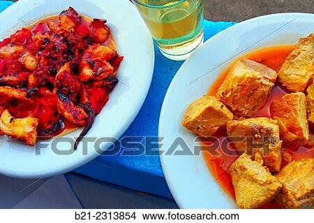 Picture - "Octopus with sauce, Taganana white wine and tuna wih onion sauce at Casa Africa bar, Roque de las Bodegas, Taganana, Tenerife, Canary Islands, Spain". Fotosearch