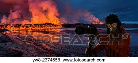Photographer wearing a gas mask in front of glowing lava. View Large Photo Image Stock Photo - Photographer wearing a gas mask in front of glowing lava.. Fotosearch