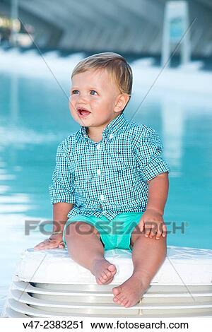 Picture a baby sitting beside a pool View Large Photo Image Stock Image - Picture a baby sitting beside a pool. Fotosearch