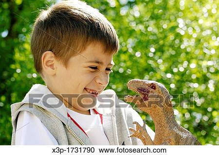 Stock Image - Playing with a Tirannosarusu rex. Fotosearch