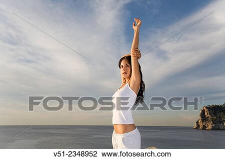 Portrait of a brunette woman breathing fresh air by the sea smiling at camera View Large Photo Image Stock Image - Portrait of a brunette woman breathing fresh air by the sea smiling at camera. Fotosearch