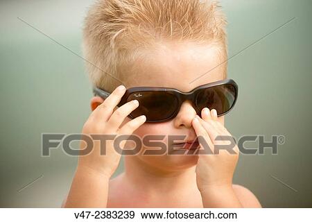Stock Photo - Portrait of a little boy with sunglasses. Fotosearch
