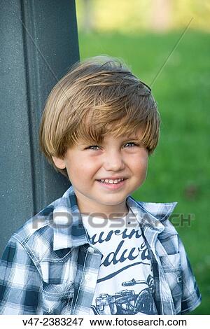 Portrait of a small boy smiling at camera View Large Photo Image Stock Photo - Portrait of a small boy smiling at camera. Fotosearch