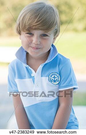 Stock Photo - Portrait of a small boy smiling at camera. Fotosearch
