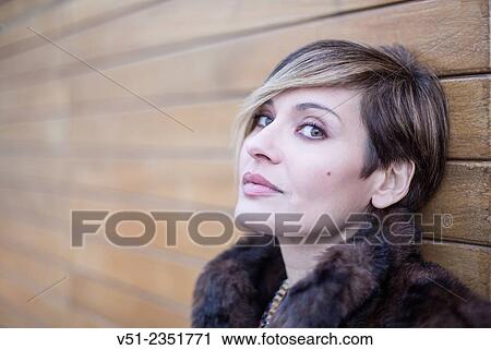 Portrait of a stylish woman outdoors looking at camera View Large Photo Image Stock Image - Portrait of a stylish woman outdoors looking at camera. Fotosearch
