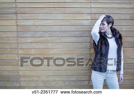 Portrait of a stylish woman outdoors looking at camera and touching her hair View Large Photo Image Stock Photo - Portrait of a stylish woman outdoors looking at camera and touching her hair. Fotosearch