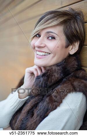 Portrait of a stylish woman outdoors smiling at camera View Large Photo Image Stock Photography - Portrait of a stylish woman outdoors smiling at camera. Fotosearch