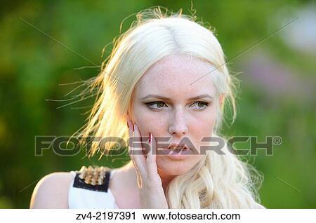 Stock Image - Portrait of a young woman at sunset.. Fotosearch