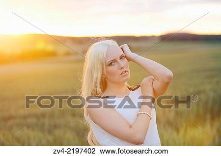 Portrait of a young woman in cornfield at sunset. View Large Photo Image Stock Image - Portrait of a young woman in cornfield at sunset.. Fotosearch