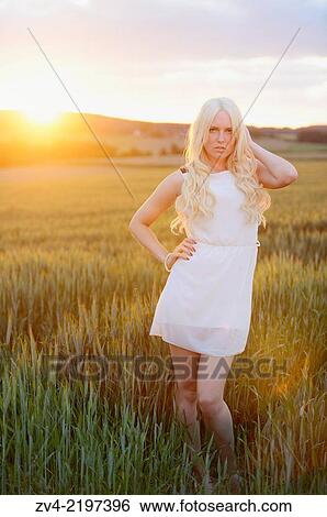Portrait of a young woman in cornfield at sunset. View Large Photo Image Stock Photograph - Portrait of a young woman in cornfield at sunset.. Fotosearch